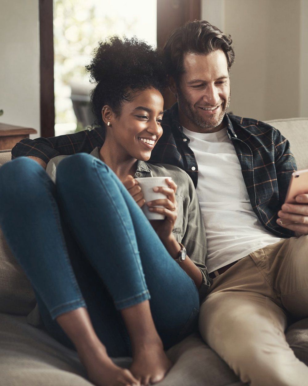 A couple in their late fifties reviewing documents together at home