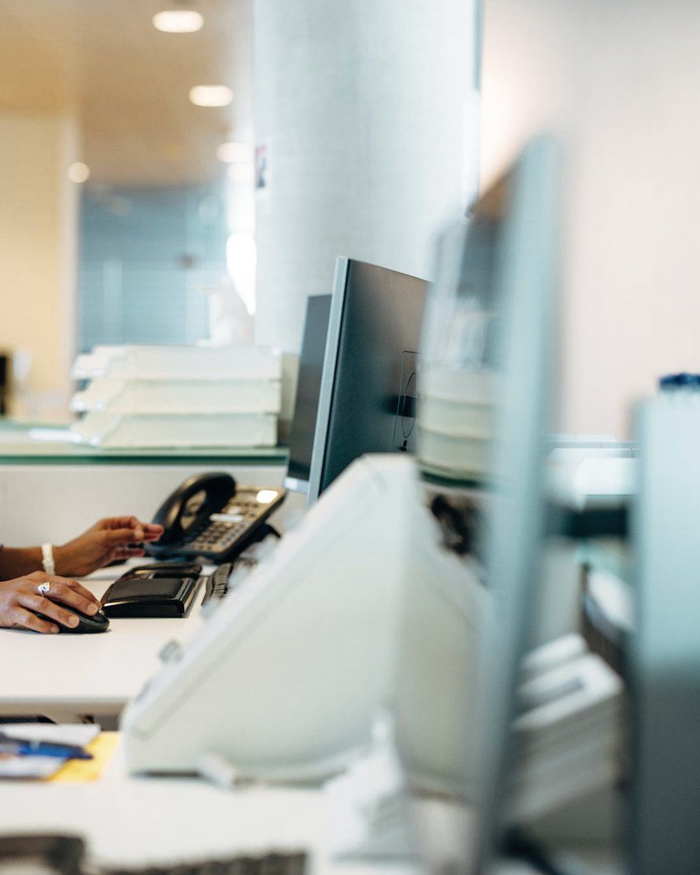 A county office workstation with a staff member at the desk